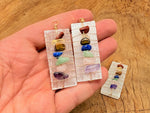 Selenite sticks pendant with chakra stones and gemstone accents, showcasing a natural, polished gemstone pendant design.