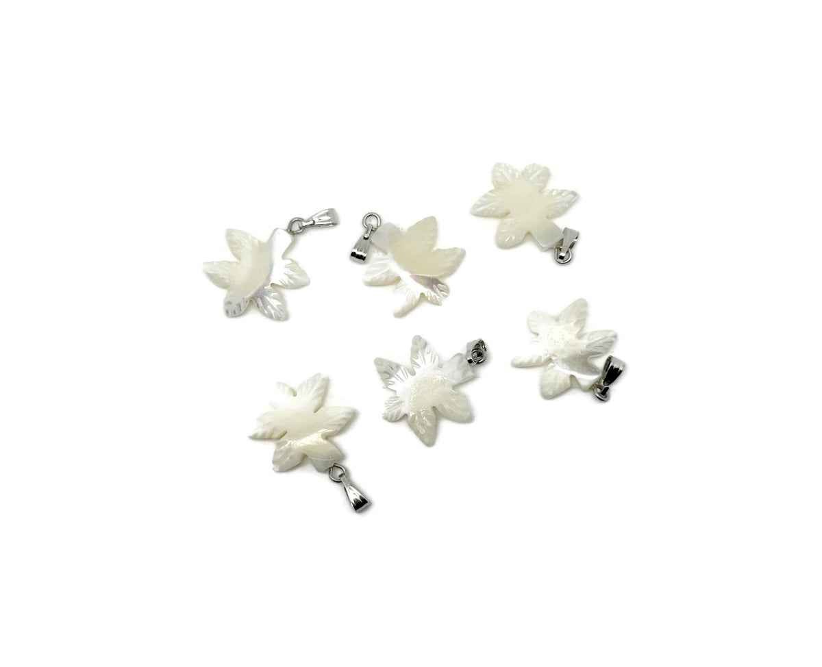 Natural pearl and sea shell cloverleaf gemstone pendant with intricate design, showcasing a delicate and elegant jewelry piece.