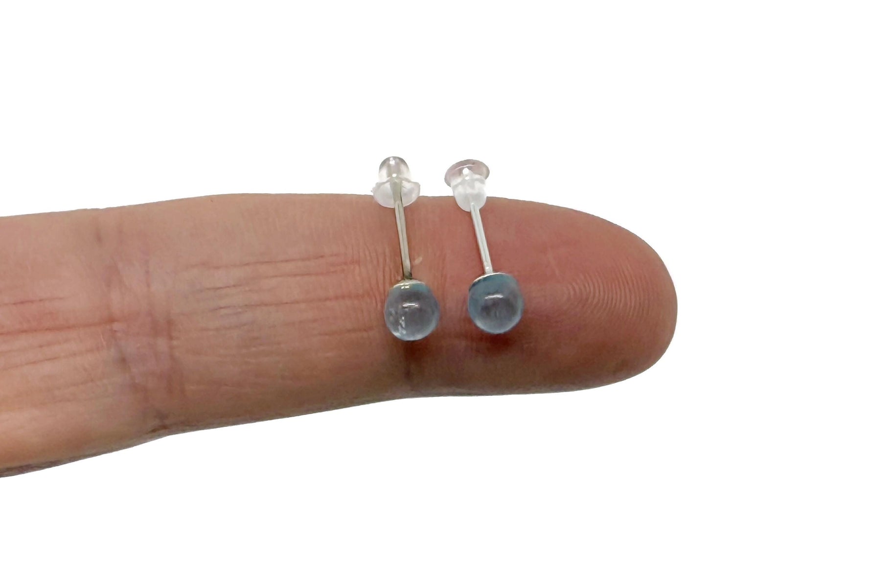 Sterling silver aquamarine stud earrings with crystal accents, showcasing a clear blue gemstone design by GemstoneGO.