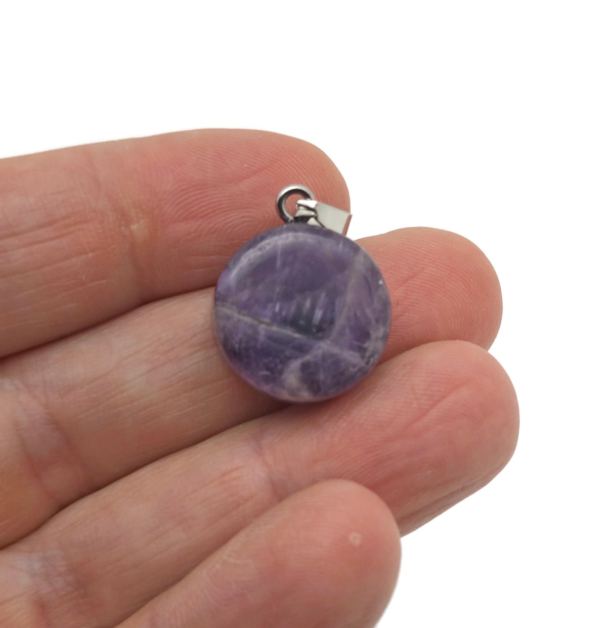 Amethyst flat round gemstone pendant with a crystal coin design, showcasing a purple amethyst stone on a silver setting.