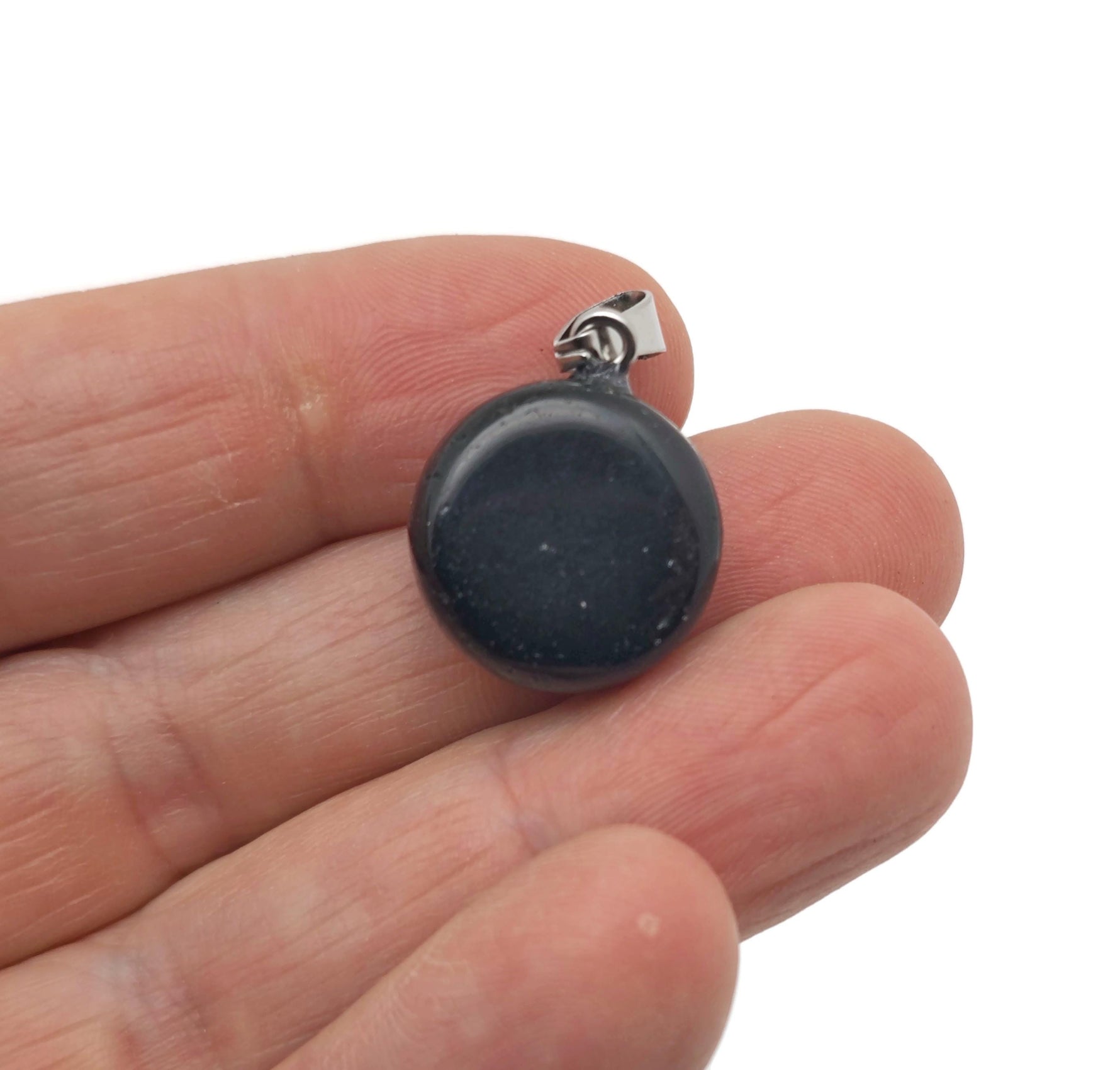 Obsidian flat round gemstone pendant with a polished crystal coin design, featuring a smooth, glossy black surface.