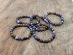Rainbow tourmaline beaded crystal bracelet with stretchy band, suitable for men and women, featuring vibrant multicolor gemstones.