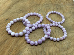 Kunzite beaded crystal stretch bracelet for men and women, featuring polished gemstones for healing and stylish wear.