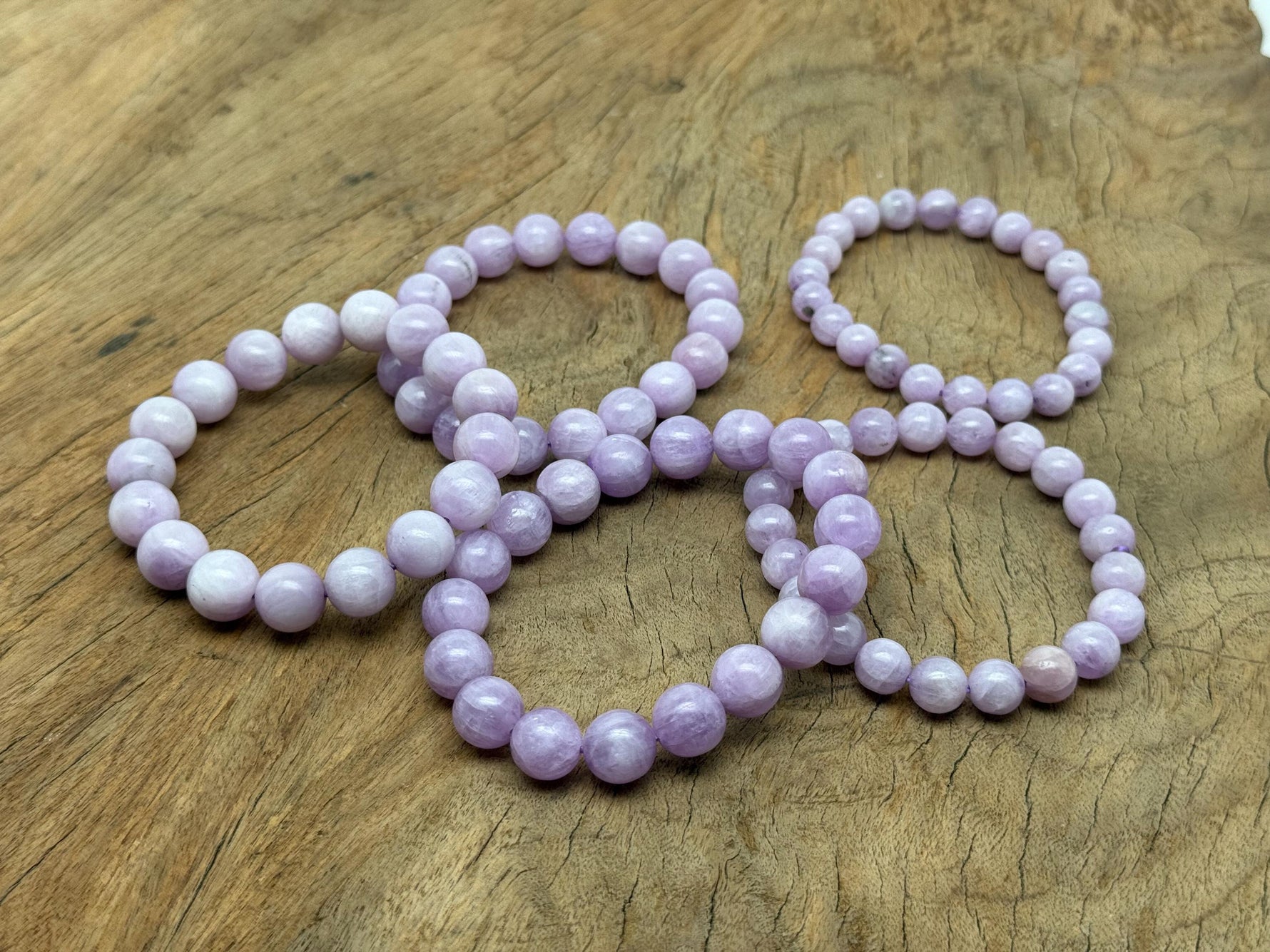 Kunzite beaded crystal stretch bracelet for men and women, featuring polished gemstones for healing and stylish wear.
