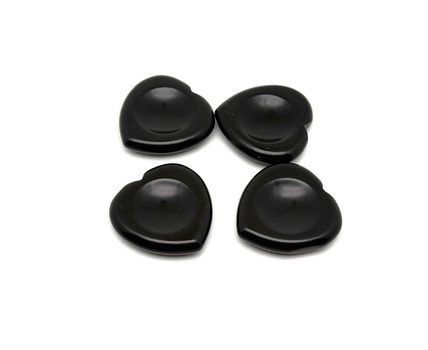 Polished black obsidian heart worry stone from GemstoneGO, smooth soothing crystal for stress relief and meditation.