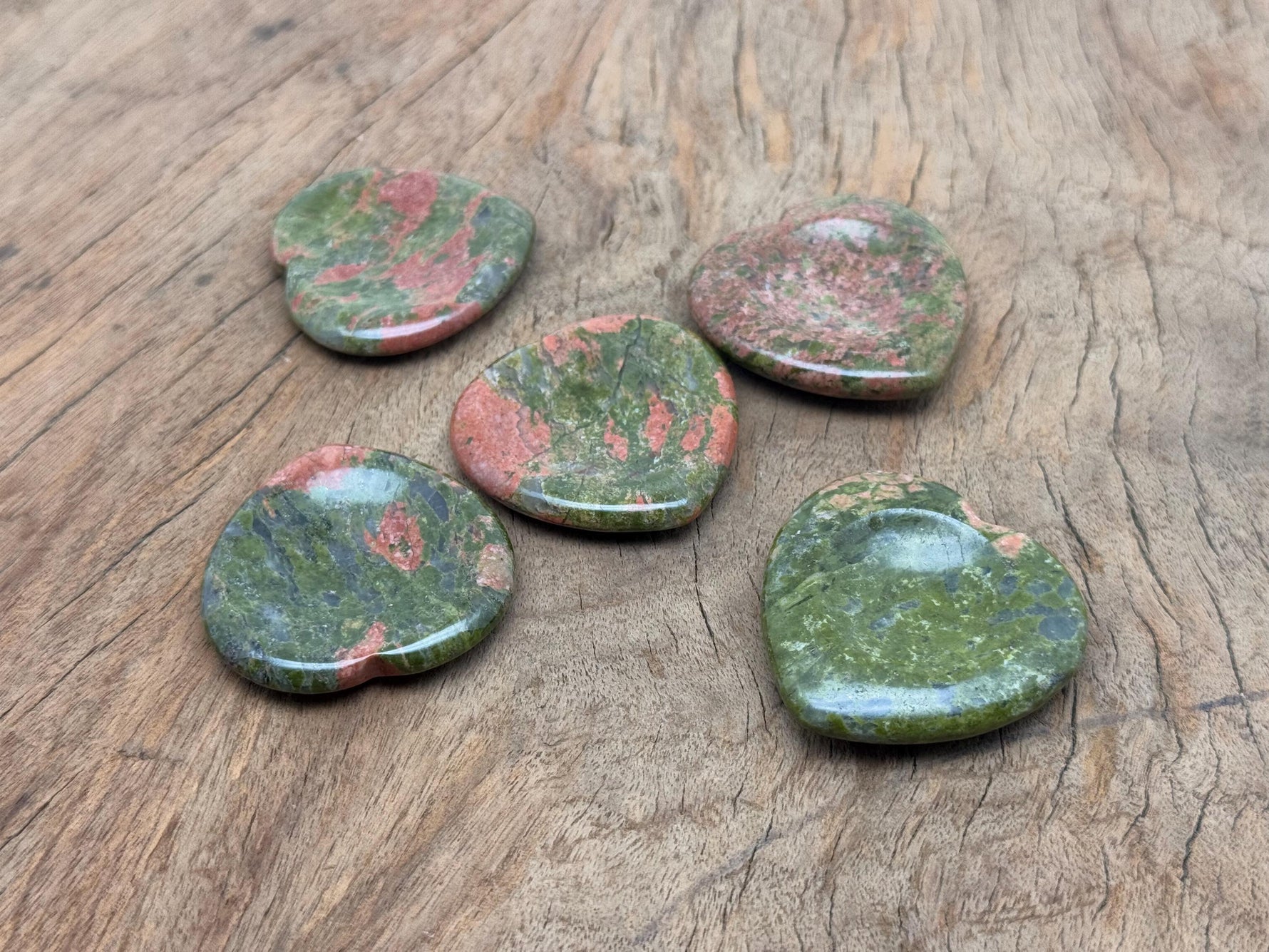 Unakite heart worry stone from GemstoneGO, soothing crystal with pink and green hues, oval-shaped gemstone for stress relief.