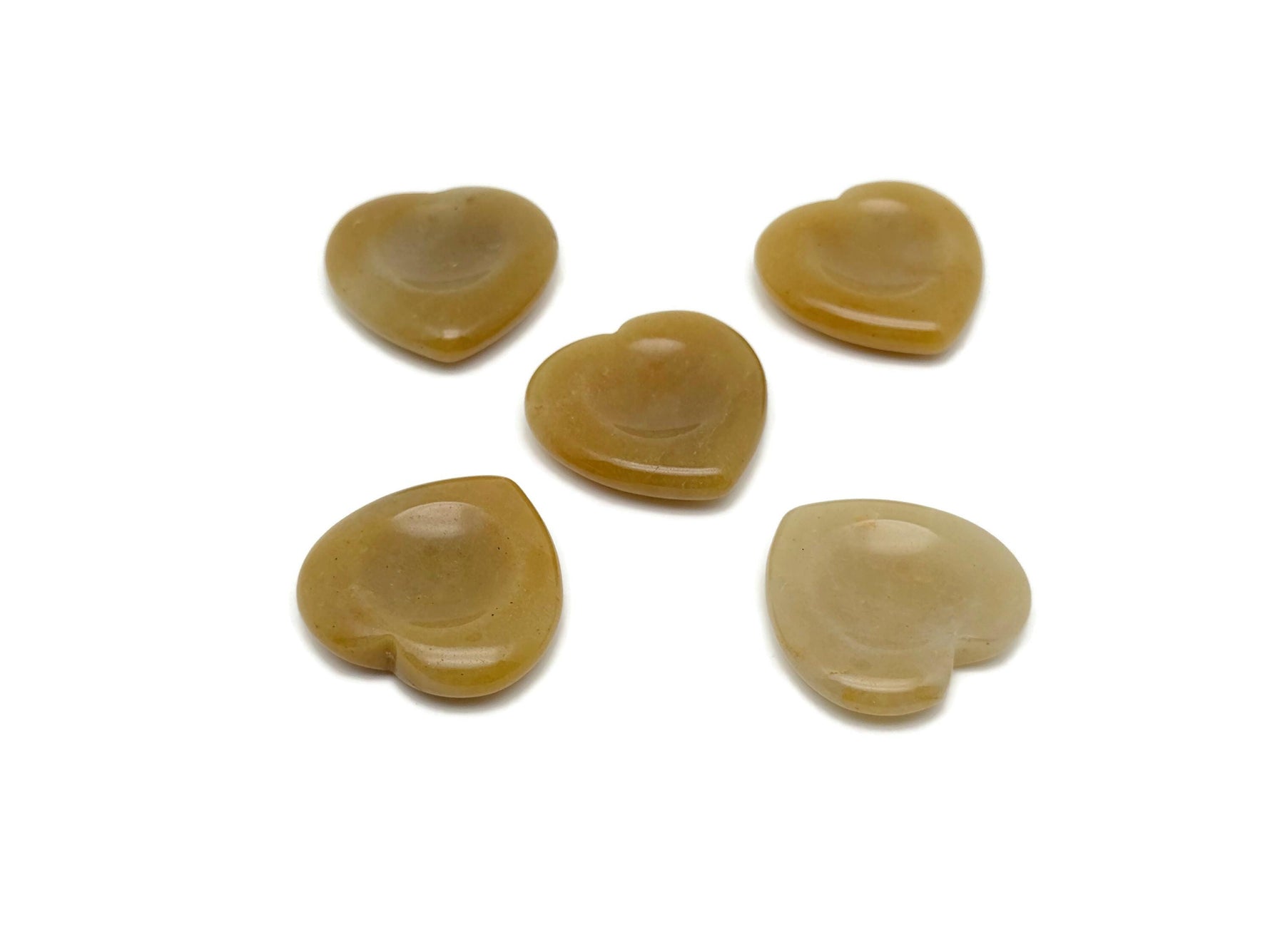 Yellow jade heart worry stone from GemstoneGO, smooth soothing crystal with polished surface and vibrant yellow color.