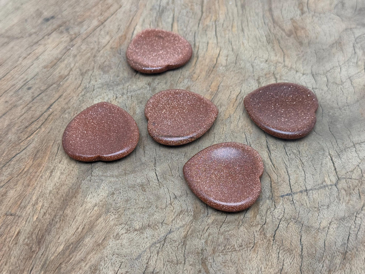 Goldstone Heart worry stone from GemstoneGO, a soothing crystal with a polished gold-colored heart shape for stress relief.