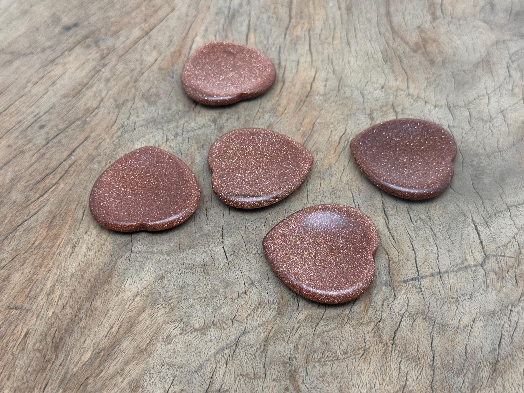 Goldstone Heart worry stone from GemstoneGO, a soothing crystal with a polished gold-colored heart shape for stress relief.