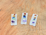 Selenite sticks pendant with chakra stones gemstone pendant, showcasing a natural crystal design with a silver chain.