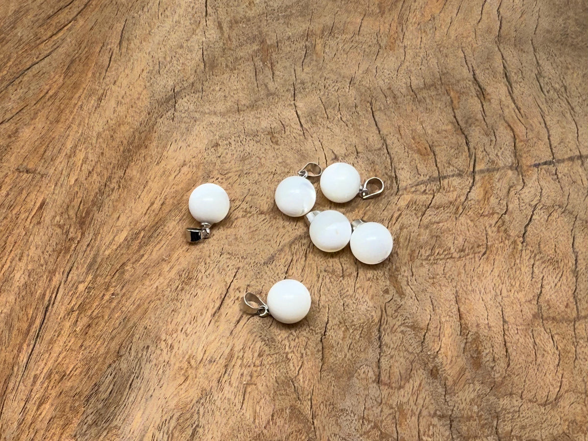 Natural pearl and seashell gemstone pendant from GemstoneGO featuring a spherical pearl ball and shell accents.
