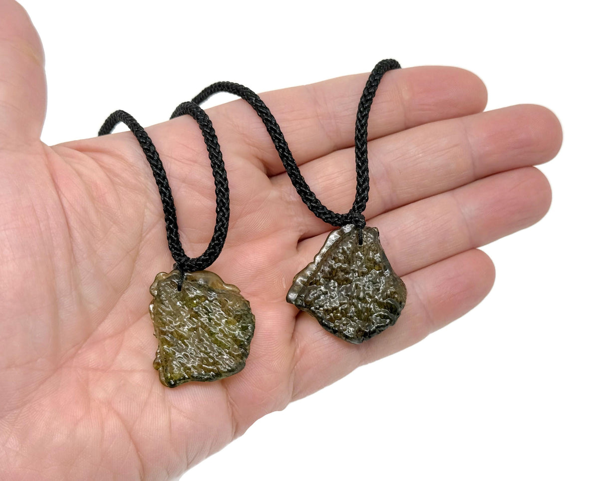 Green Moldavite pendant necklace with a polished gemstone, ideal for spiritual growth and connected to the GemstoneGO collection.