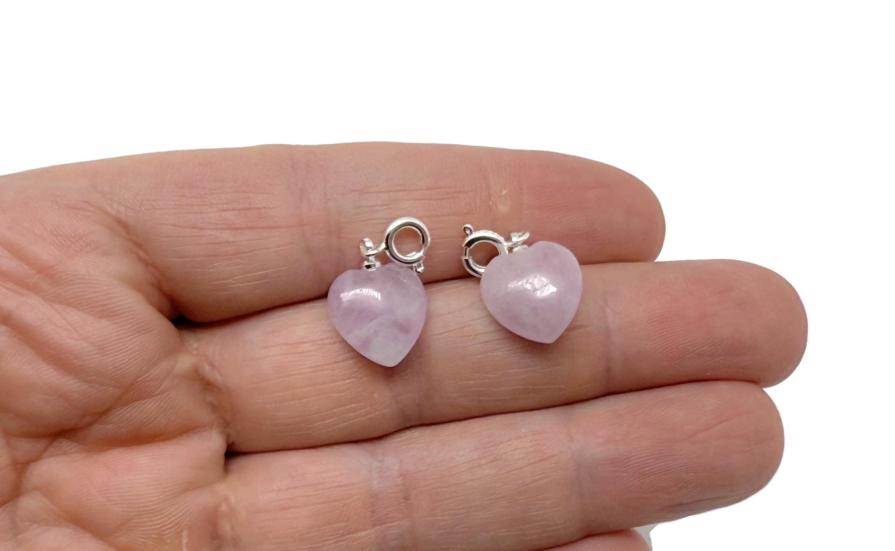 Kunzite heart-shaped crystal pendant from GemstoneGO, miniature jewelry with pinkish purple hues and polished gemstone finish.