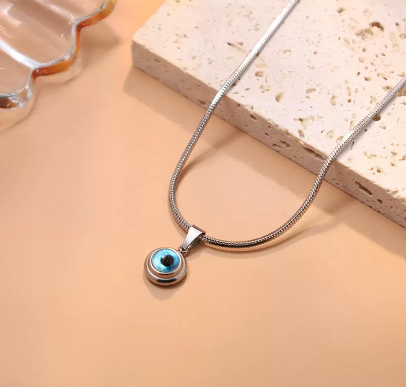 Gold and silver mini evil eye pendant with Nazar design, featuring a protective evil eye charm from GemstoneGO.
