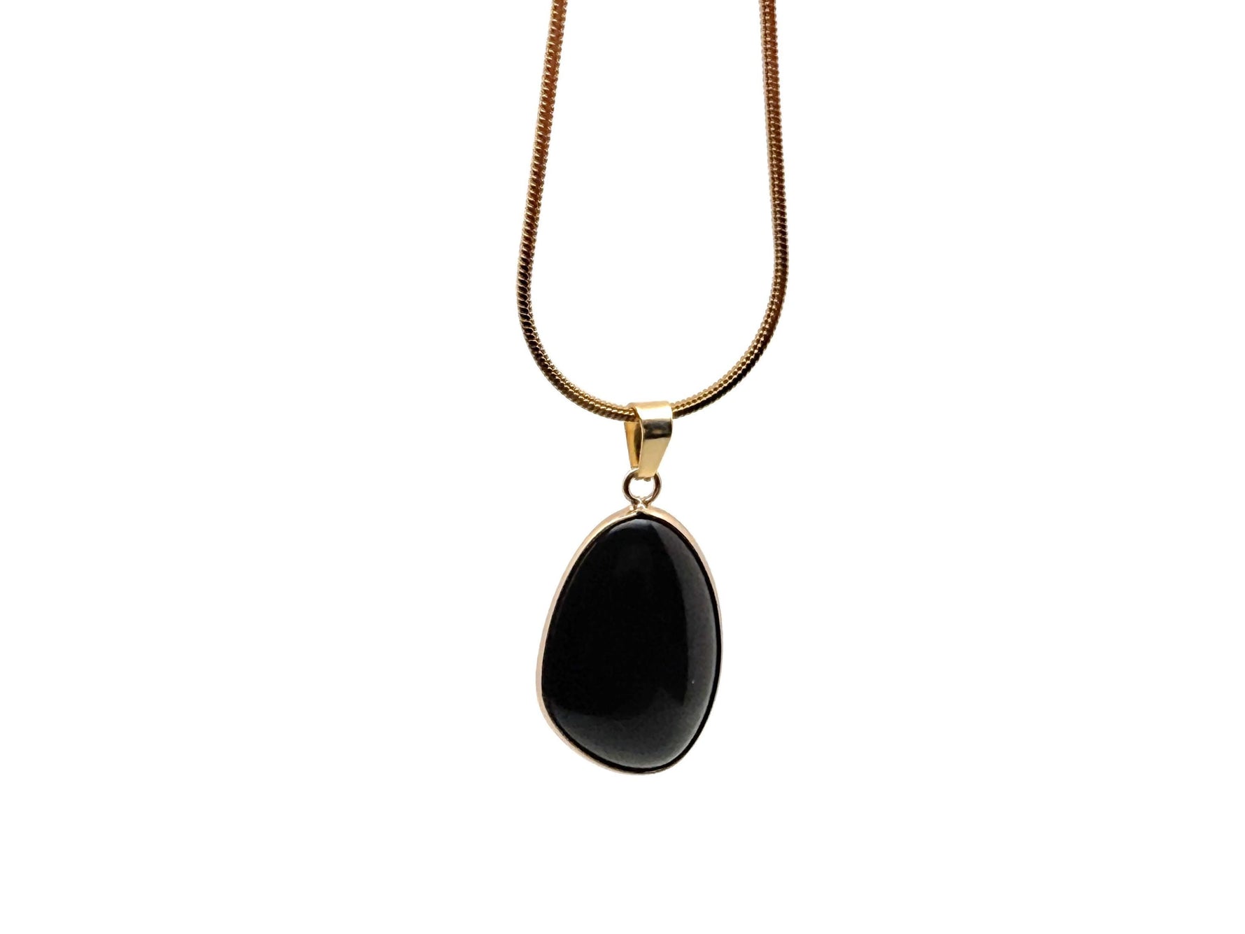 Dainty obsidian gold gemstone pendant with a smooth, polished surface, displayed with jewelry charms from GemstoneGO.