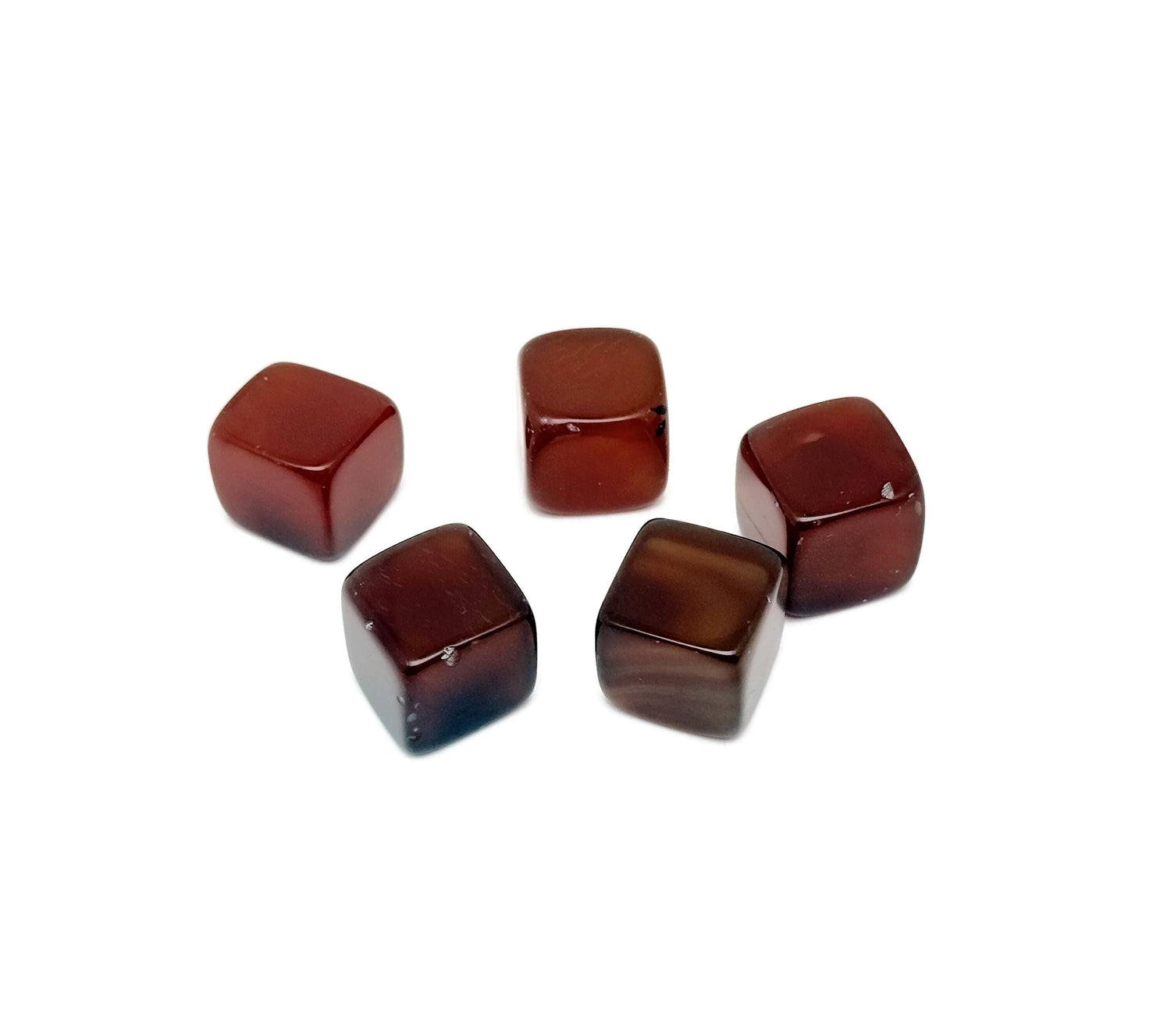 Handmade 16mm carnelian cube gemstone from GemstoneGO, showing a polished orange-red carved stone on a plain background.