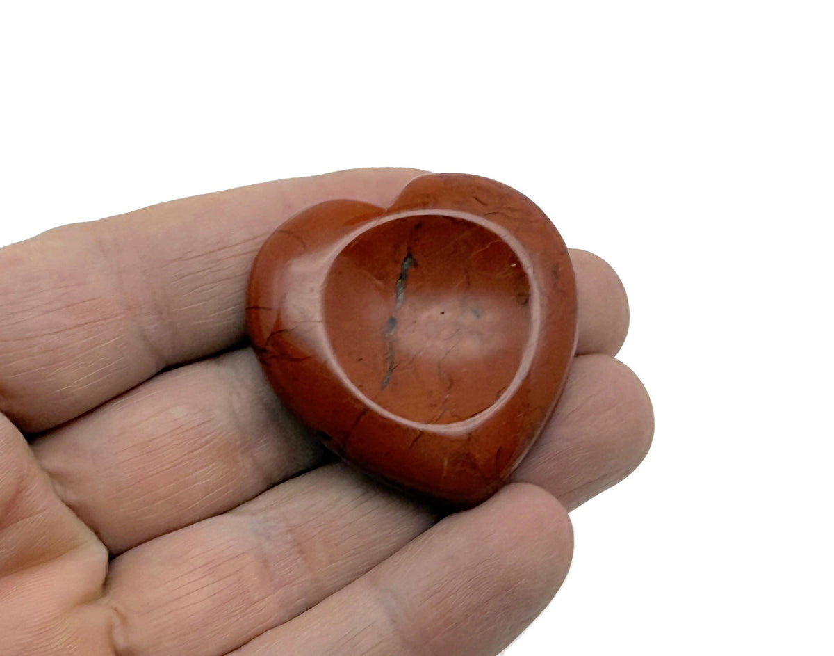 Red Jasper heart worry stone from GemstoneGO, a soothing crystal for stress relief and emotional calm, shown in close-up.