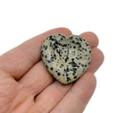 Dalmatian Jasper heart worry stone from GemstoneGO, a soothing crystal with distinctive black and cream spots, used for calming and stress relief.