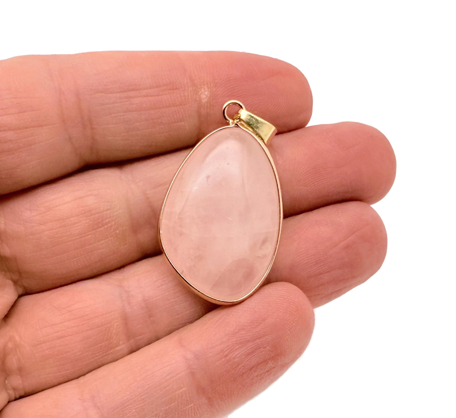 Dainty rose quartz gemstone pendant with gold setting, ideal for DIY jewelry charms, showcasing a smooth, polished pink stone.
