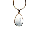 Dainty Howlite gemstone pendant with gold accents, ideal for DIY jewelry charms, showcasing a smooth, polished stone.