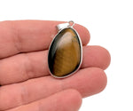 Dainty silver pendant featuring a polished tiger eye gemstone, ideal for DIY jewelry charms by GemstoneGO.