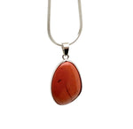 Red Jasper silver gemstone pendant with dainty design, showcasing a polished red jasper stone on a silver setting.