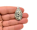 Dalmatian Jasper silver gemstone pendant from GemstoneGO featuring a dainty jewelry charm with black and cream spots.