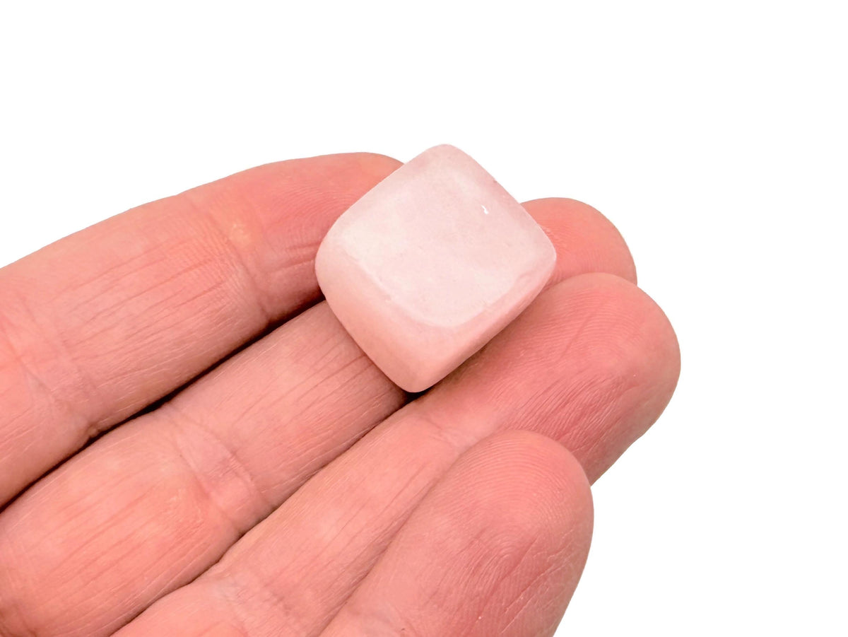 Handmade 16mm rose quartz cube stone from GemstoneGO with carved detail, showcasing its soft pink color and smooth polished surface.