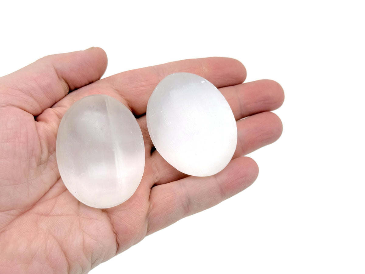 Selenite palm gemstone spa stone, 50mm size, smooth and polished for relaxation and meditation use.