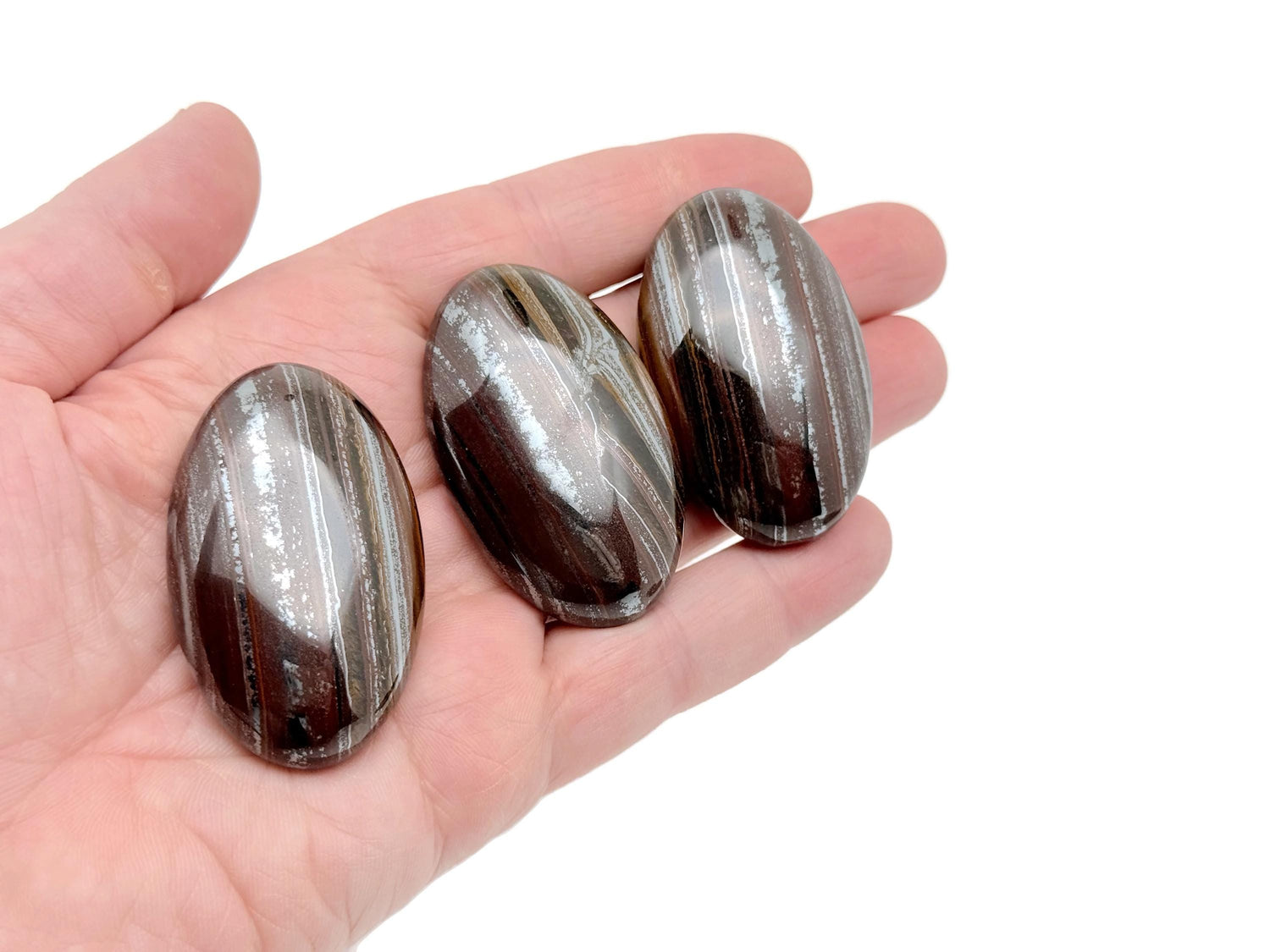 Tiger Iron palm gemstone spa stone from GemstoneGO, 50-60mm, showing polished, multicolored tiger iron with smooth surface and natural pattern