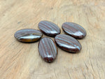 Tiger Iron Palm Gemstone Spa Stone, 50-60mm, featuring rich layered tiger iron for soothing massage and healing purposes.
