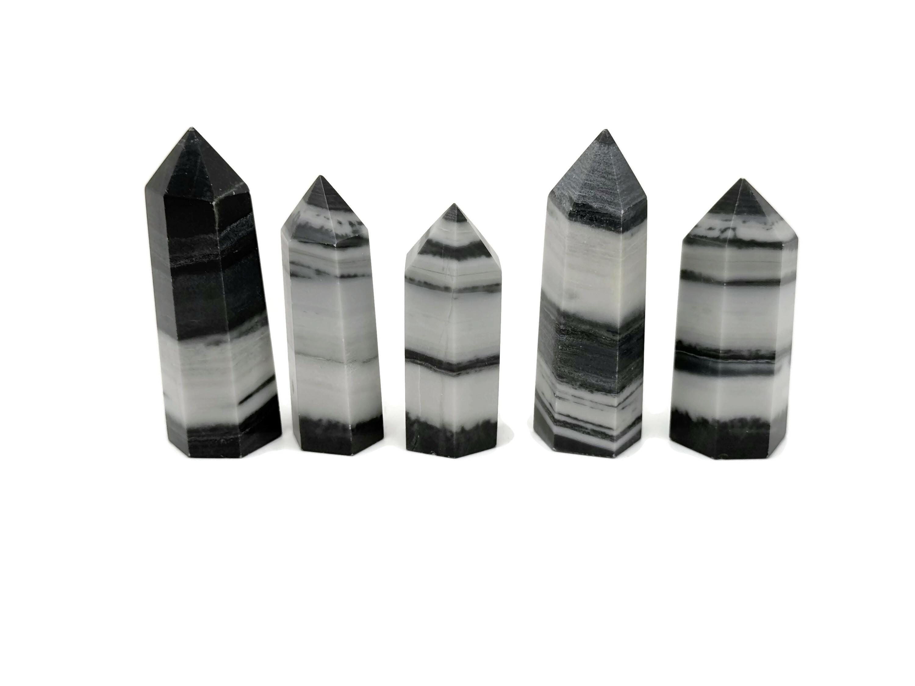 Tai Chi Jade Obelisk Tower with Yin Yang design, made from green jade gemstone, detailed and polished surface.