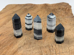 Tai Chi Jade Obelisk Tower featuring yin yang jade gemstone, polished crystal with intricate details, on a neutral background.