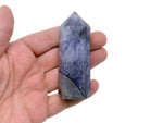Purple agate obelisk tower crystal from GemstoneGO, showcasing a polished purple gemstone with natural banding and a pointed top.