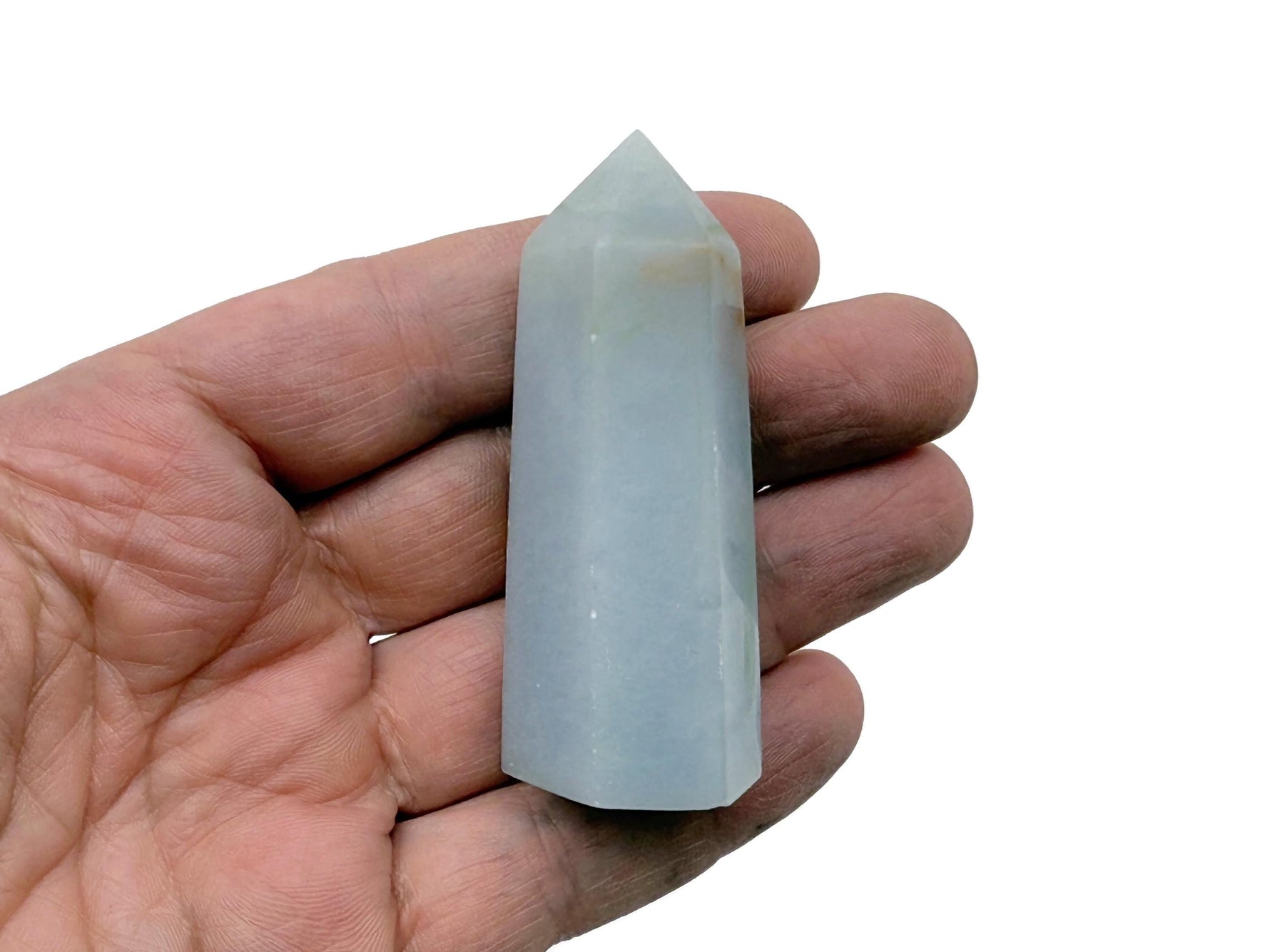 Angelite obelisk tower crystal from GemstoneGO, showing a smooth, pale blue gemstone with natural veining and a pointed top.