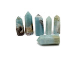 Caribbean Calcite obelisk tower crystal from GemstoneGO with smooth, polished surface and natural orange and beige tones.