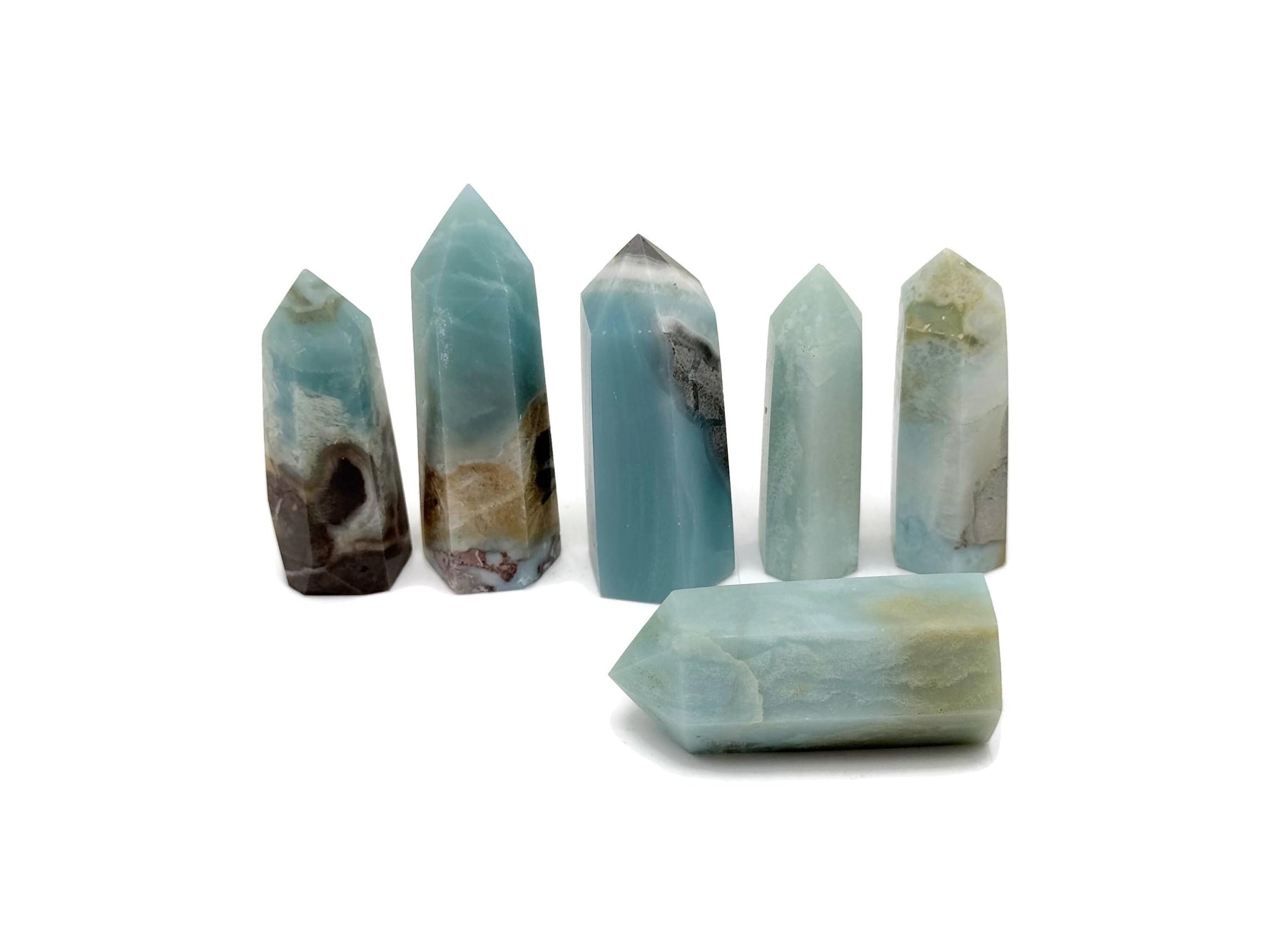 Caribbean Calcite obelisk tower crystal from GemstoneGO with smooth, polished surface and natural orange and beige tones.
