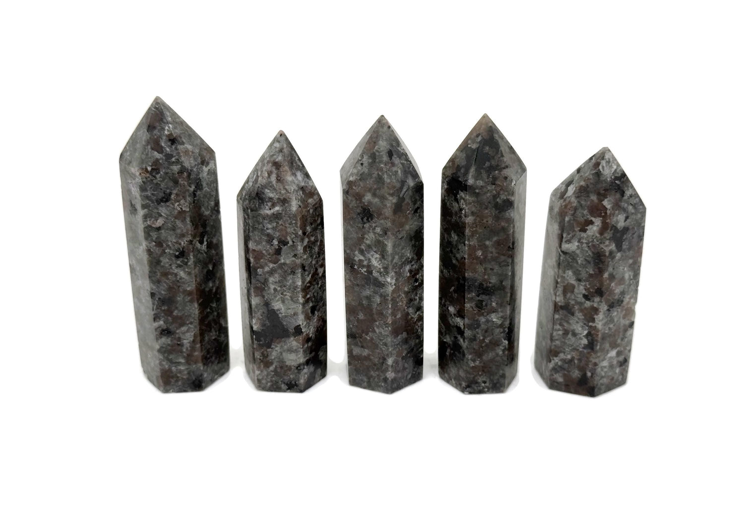 Yooperlite obelisk tower crystal featuring fluorescent sodalite stone with vibrant blue and purple hues, displayed against a neutral background.