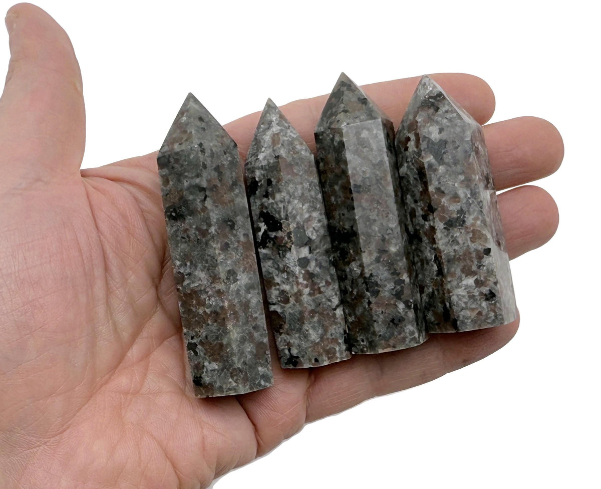 Yooperlite obelisk tower crystal with fluorescent sodalite stone, showcasing vibrant blue and white mineral patterns.