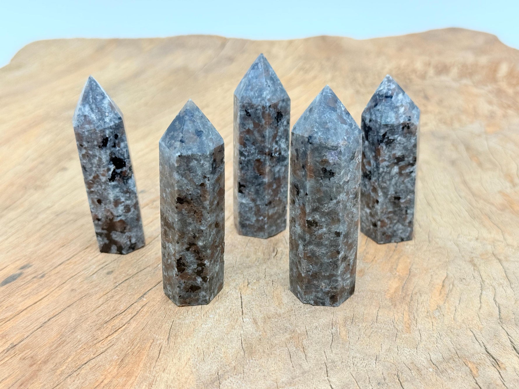 Yooperlite obelisk tower crystal featuring fluorescent sodalite stone with vibrant blue and purple hues, from GemstoneGO.