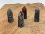 African Bloodstone obelisk tower crystal by GemstoneGO, showcasing a dark green stone with red bloodstone inclusions.