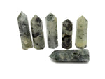 Prehnite obelisk tower crystal from GemstoneGO, showcasing a smooth, green gemstone with natural mineral patterns and a pointed tip.