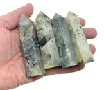 Prehnite obelisk tower crystal by GemstoneGO, showcasing a green gemstone with smooth polished surfaces and natural mineral patterns.