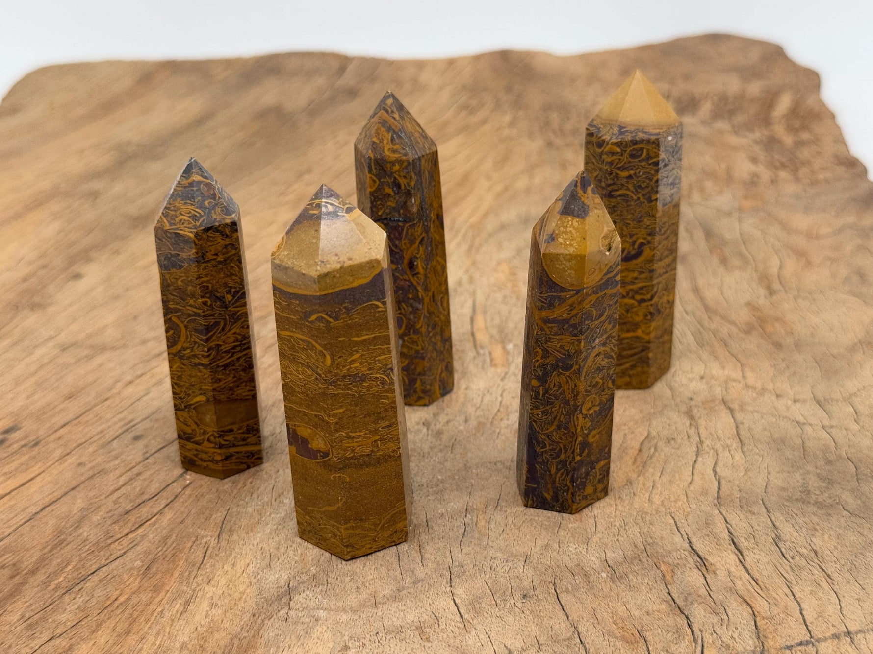 Calligraphy Jasper obelisk tower crystal by GemstoneGO, showcasing a polished brown and beige stone with natural patterns.
