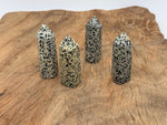 Dalmatian Jasper obelisk tower crystal from GemstoneGO, showcasing black spots on cream stone with a pointed top.