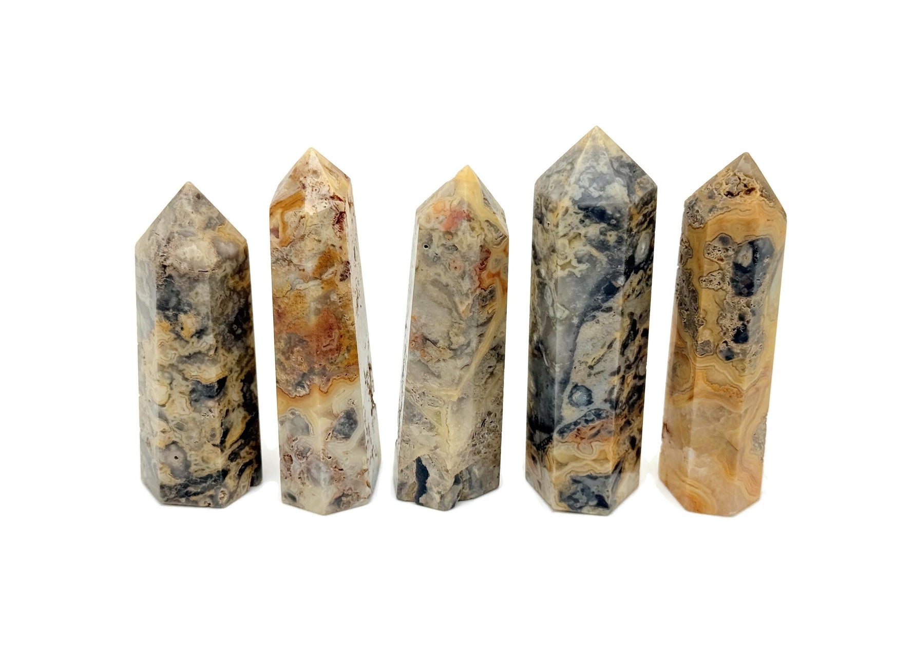Crazy Lace Agate obelisk tower crystal from GemstoneGO, showing vibrant banded patterns and polished pointed shape.