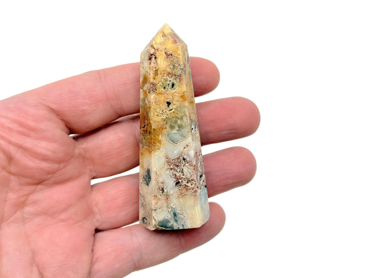 Crazy Lace Agate obelisk tower crystal from GemstoneGO, featuring vibrant banding and intricate patterns in a tall, polished gemstone.