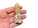 Crazy Lace Agate obelisk tower crystal from GemstoneGO, featuring vibrant banding and intricate patterns in a tall, polished gemstone.