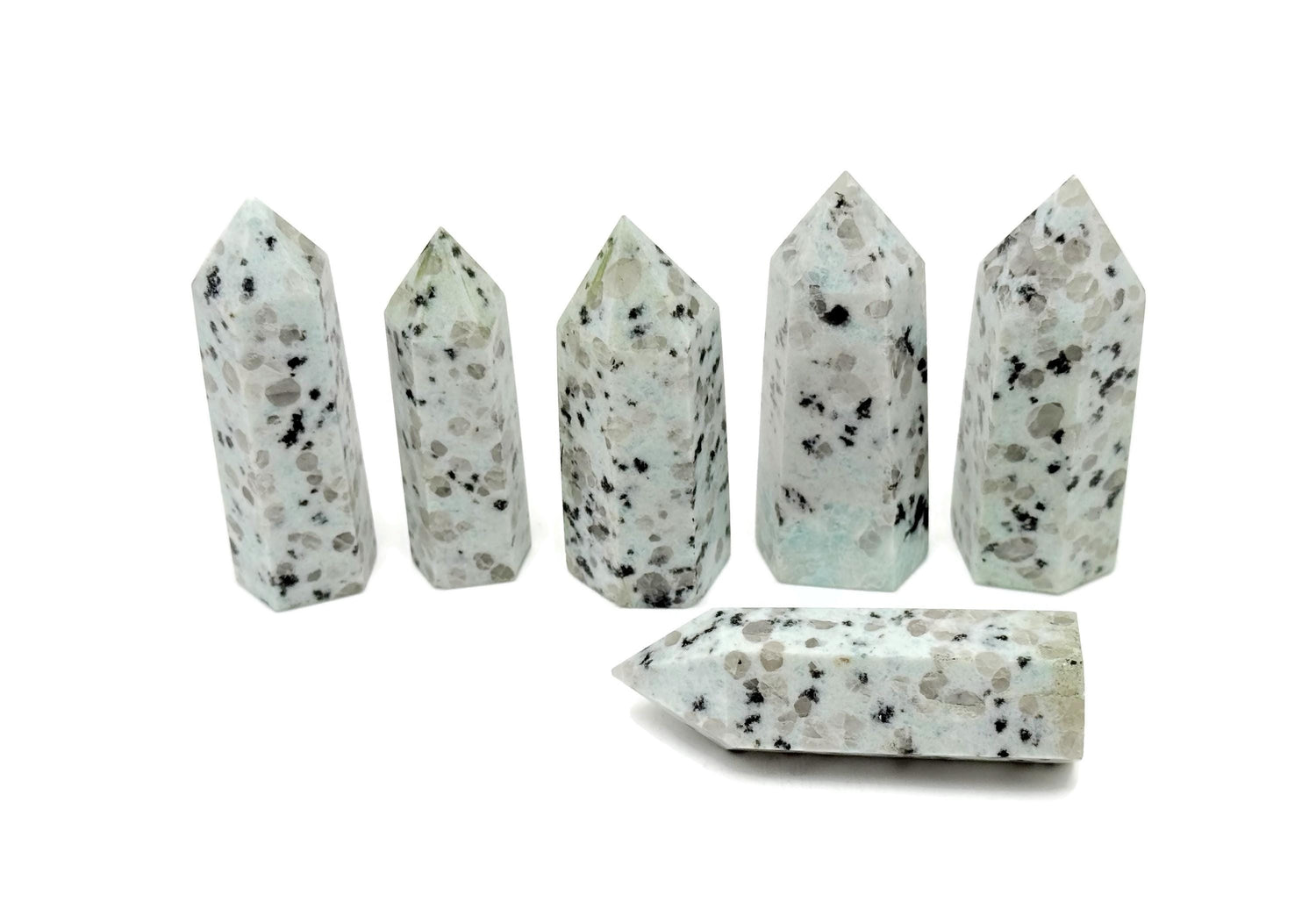 Kiwi Jasper obelisk tower crystal from GemstoneGO, featuring a polished green and brown stone with natural patterns and a pointed top.
