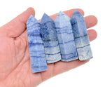 Blue aventurine obelisk tower crystal from GemstoneGO, featuring a polished blue gemstone obelisk with natural veining and smooth surfaces.